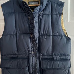 J. Crew Navy Blue Puffer Vest brand new, never worn. Features snap pockets.